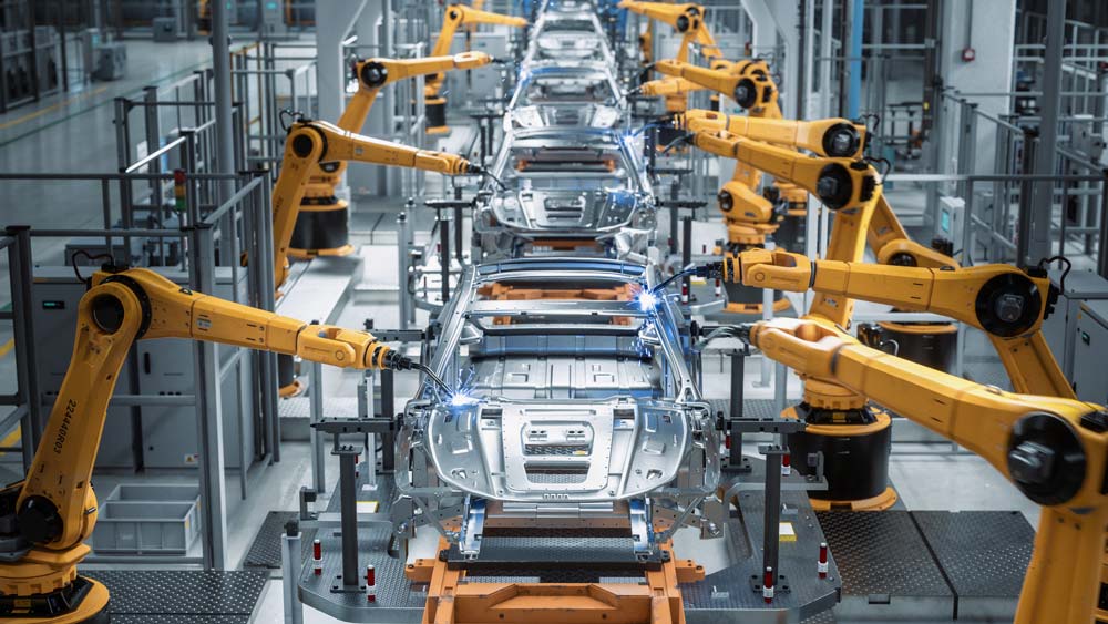robots on an assembly line are assembling cars